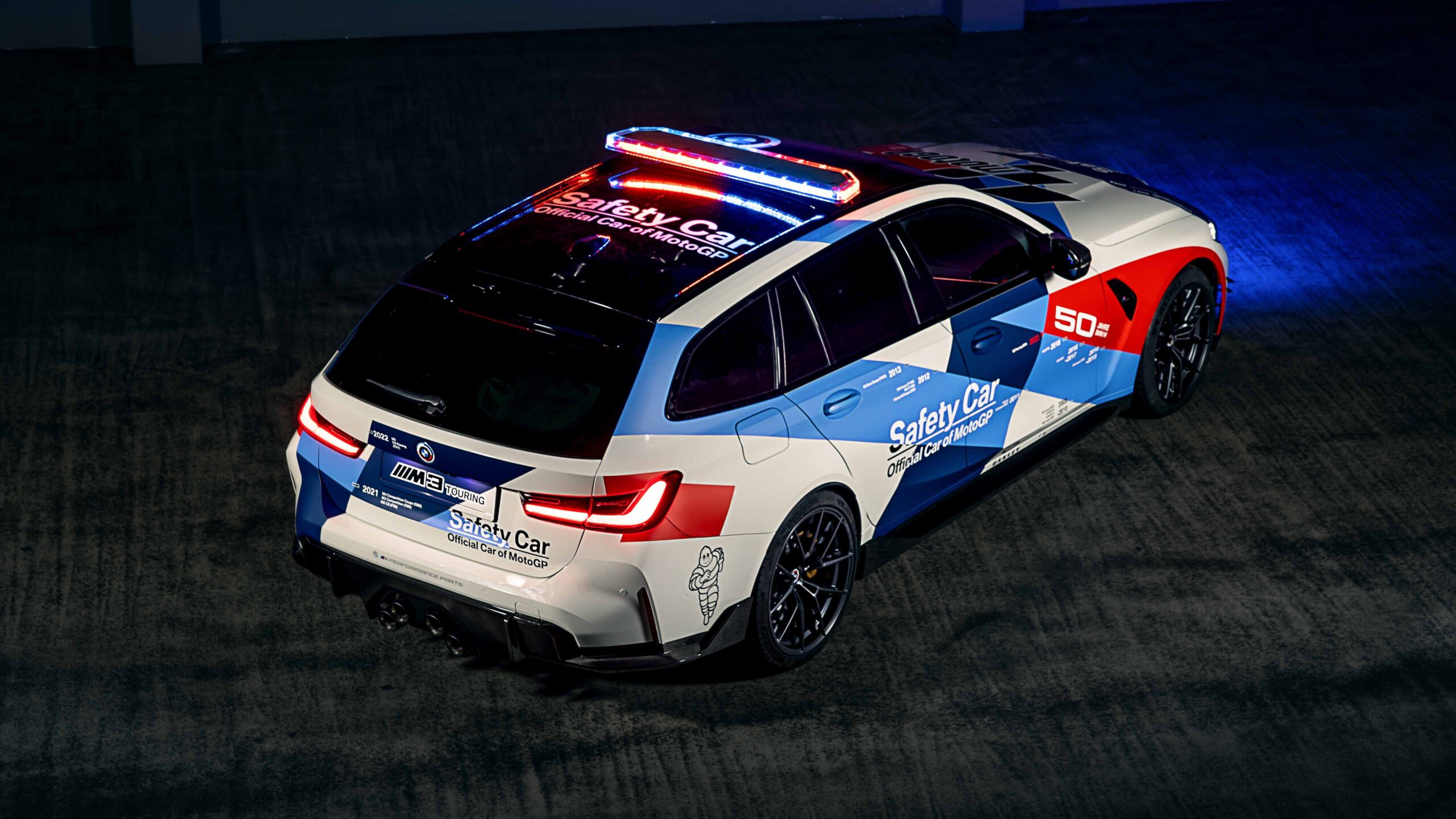 BMW M3 Touring MotoGP Safety Car Papel de parede da perua BMW M3 Touring (G81) como Safety Car oficial do MotoGP, com pintura M Motorsport comemorativa de 50 anos, vista de trás com giroflex.
